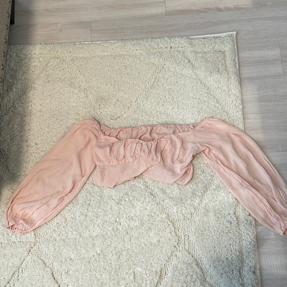Light pink size medium fits small and medium. Ties in back off the shoulder
